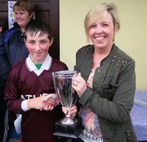 Athea U10 Captain Michael Tierney accepting the cup on behalf of Athea team from Sinead Roche in Foynes on Saturday last