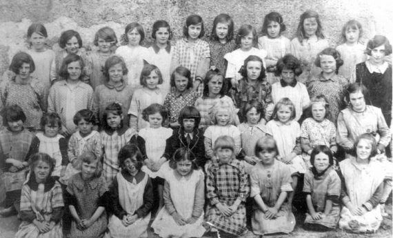 This photo was taken at Clash School, Athea,  roughly 100 years ago. There are four Sheehy sisters in the photo: Mary Sheehy (Hartigan) Carrigkerry, third from left, front row. Peg Sheehy extreme right front row, Josie Sheehy (Moore) Rooskagh, seventh from left, third row and Kit Sheehy (Williams) Rathkeale second from right, back row. Can anyone identify any of the others? if so please let us know.  