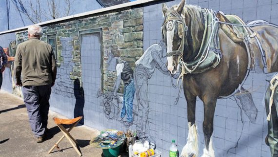 Work underway at the Athea Mural by artist James Dunn 