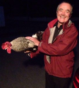 Michael Hayes saying goodbye to his prize cock before it goes to its new home in Knockaderry 