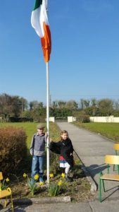 Pa Dillon and Clodagh Prendeville raise the National flag in Ballyhahill N.S. on March 15th to commemorate the centenary of 1916 
